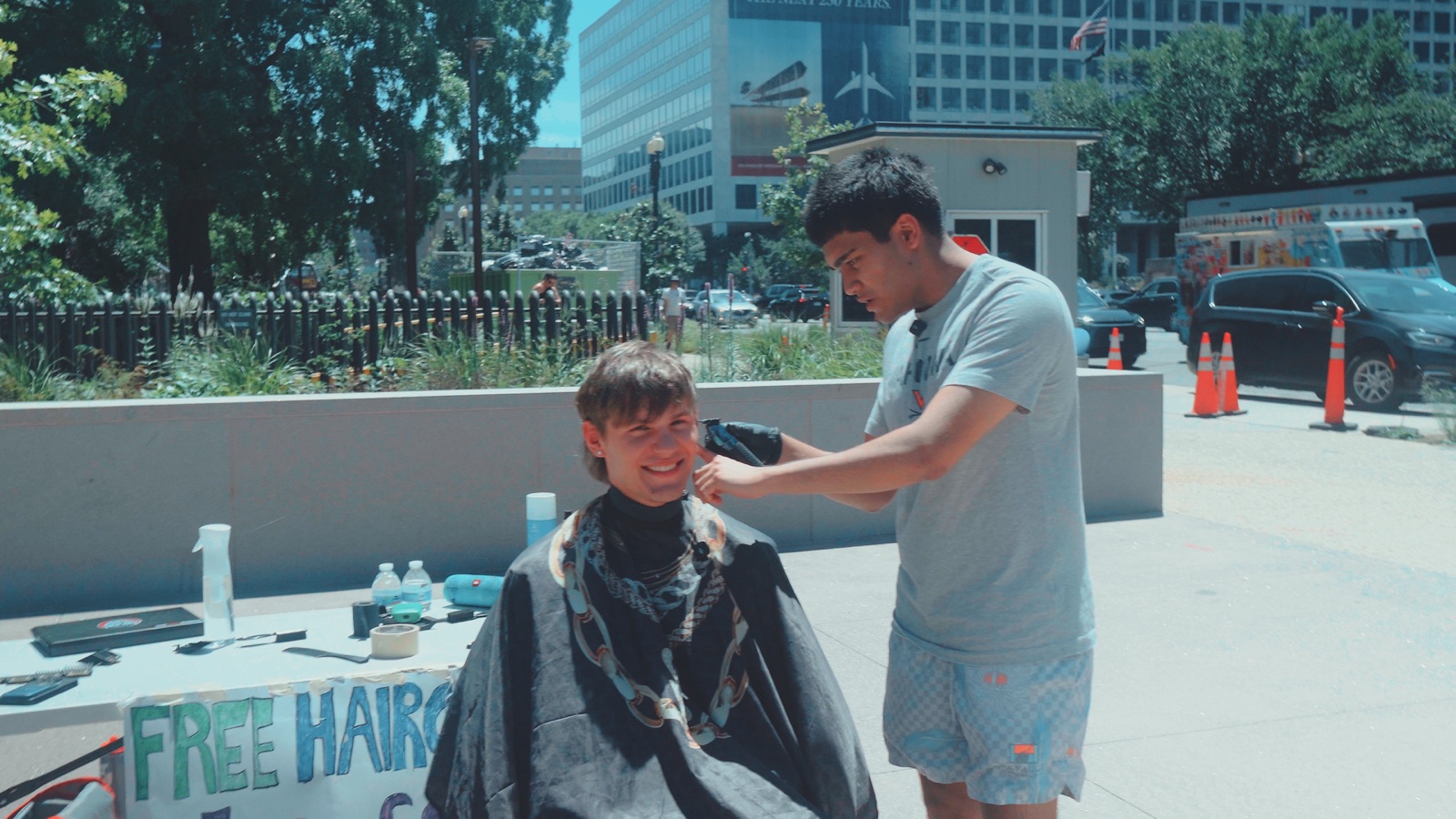 A Cuts4Change haircut in progress outdoors