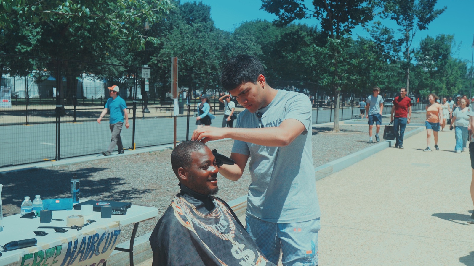 Omeed giving a free haircut outdoors in Washington, D.C.